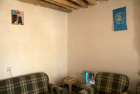 A picture of Abdullah Ocalan, former leader of the PKK, hangs across from a UNHCR flag on the wall of a refugee camp for Turkish Kurds in Iraq.