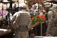 Soldiers scan the rooftops in Kirkuk, Iraq for a possible sniper