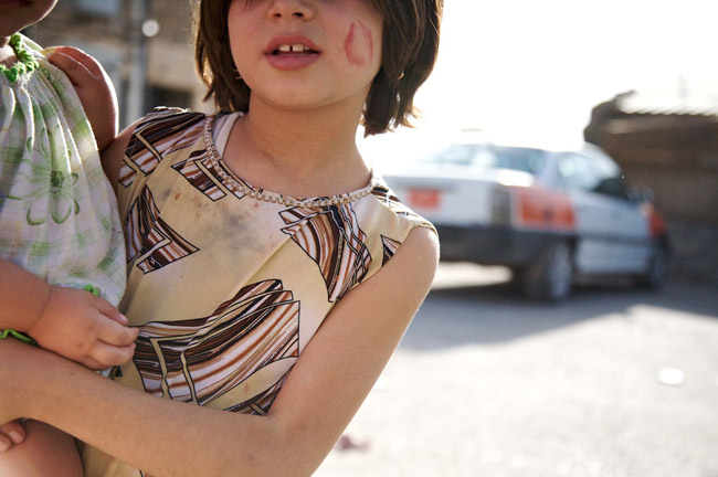 The Kiss - A girl in the Moqoble Refugee camp just outside of Dohuk, Iraq.