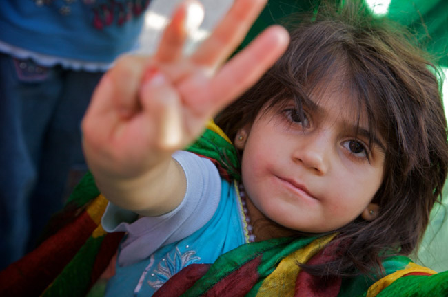 A girl is wrapped in the Kurdish flag in Bismil, Turkey.