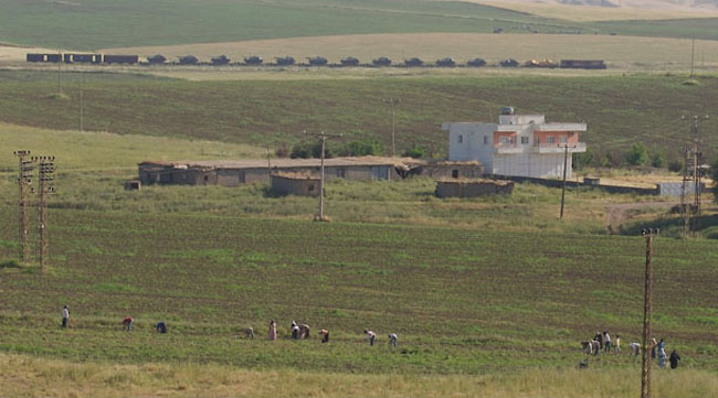 Tanks can be seen in the distance heading for the Turkey - Iraq border