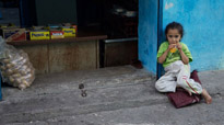 A little girl enjoys some candy on the street in Diyarbakir, Turkey