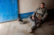 A soldier guards a doorway in a village outside of Kirkuk, Iraq
