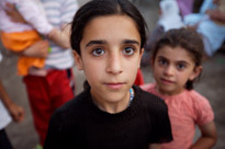 Kids pose for a photo in the street in Bismil, Turkey